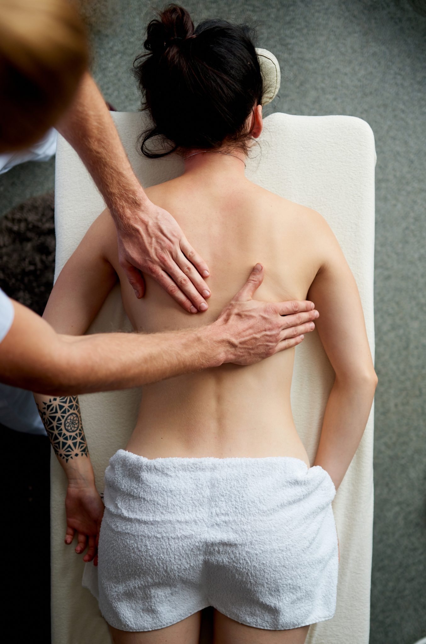 top view of masseur massaging back of woman lying       utc scaled